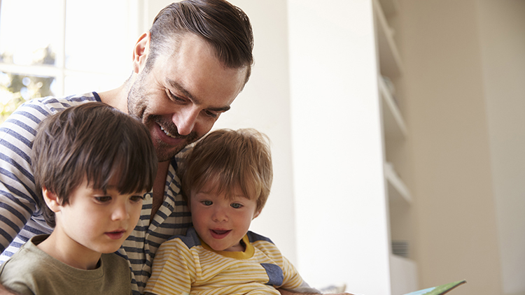 Toddlers sitting with father