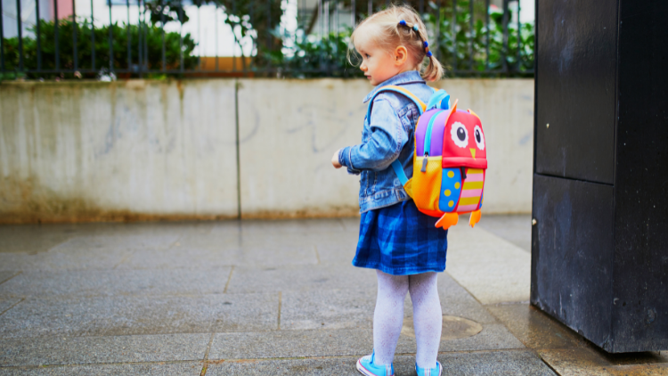 girl with backpack ready to go to nursery
