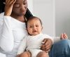 Depressed mother sitting with her crying little child