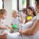 Pregnant woman with small children indoors at home