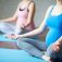 Pregnant women sitting in pose of lotus in gym