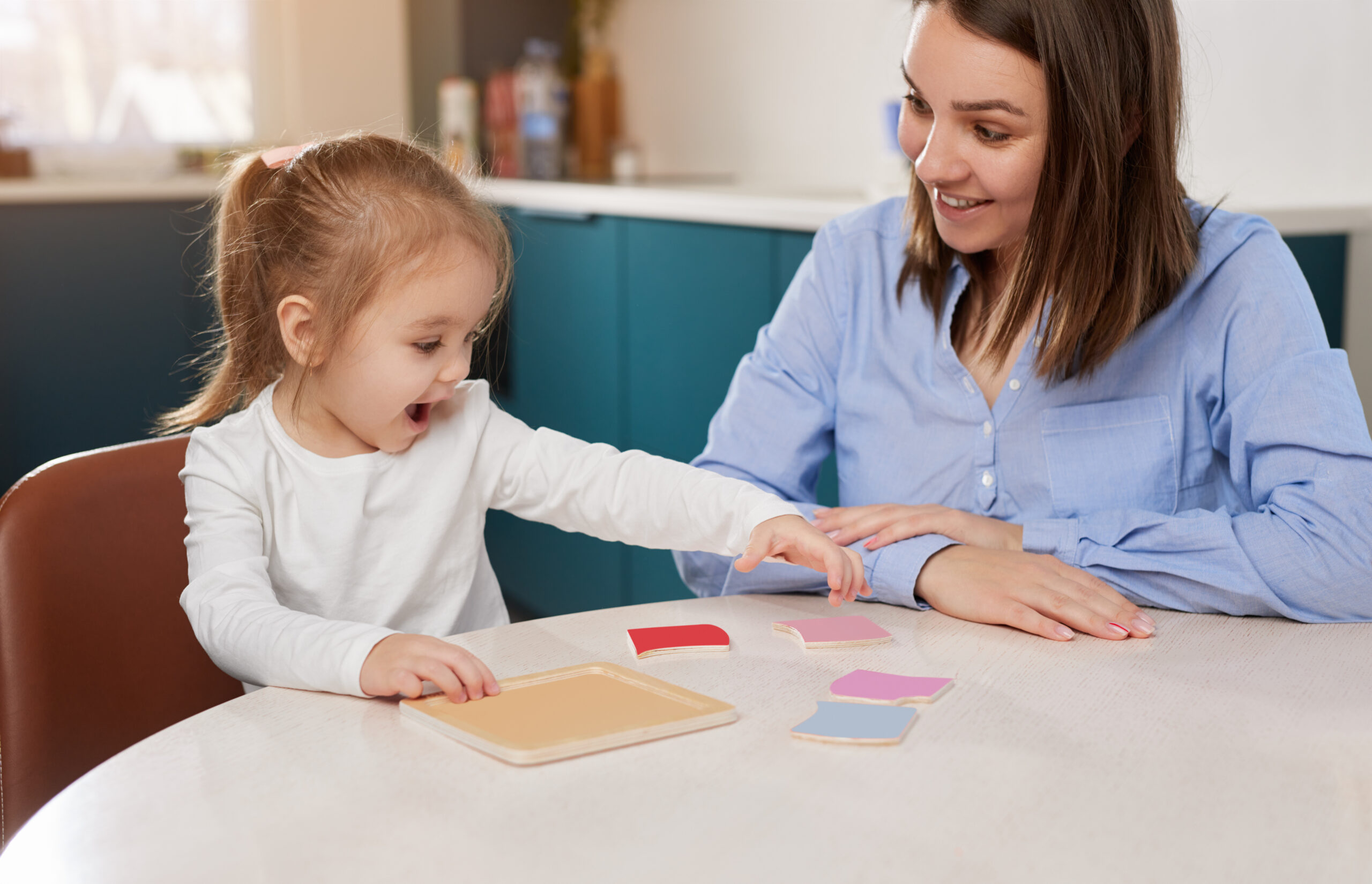 pre school child learning colours with mother