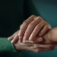 Comforting hand on hand