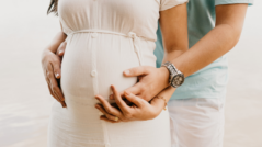 Pregnant couple holding bump