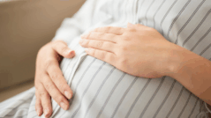 Woman holding tummy
