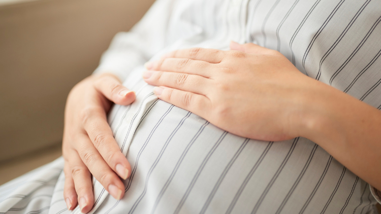 Woman holding tummy
