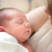 Image of mother cradling her newborn baby in her arms